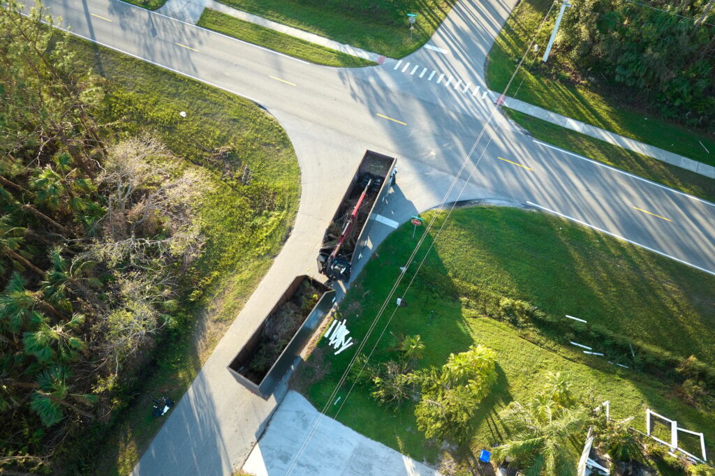 Aerial view of Hurricane Ian special aftermath recovery dump truck picking up vegetation